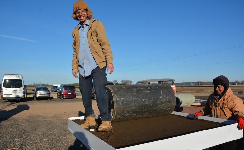 worker standing on green roof testing platform assembly